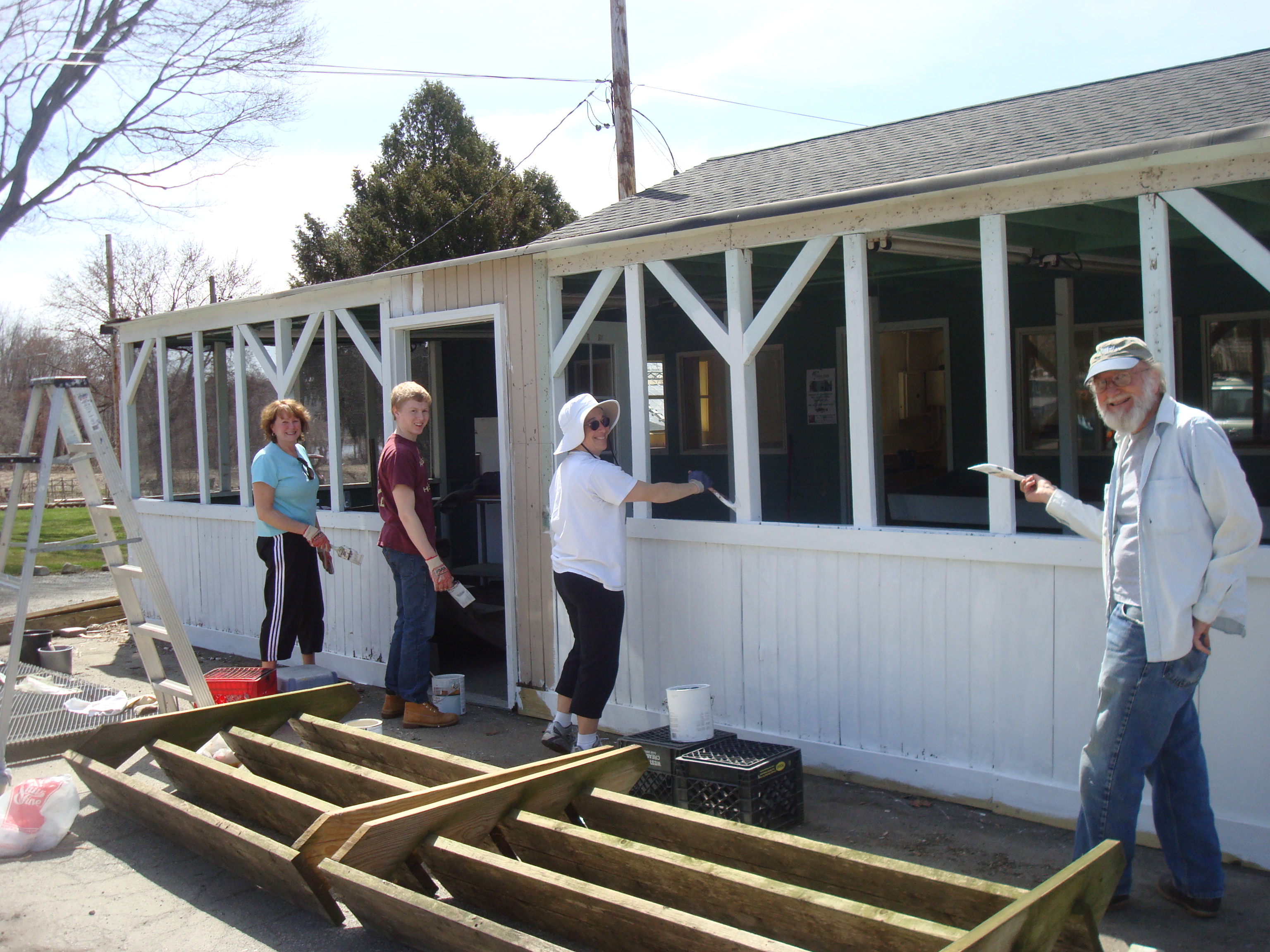 Volunteers prime the front of the farm stand