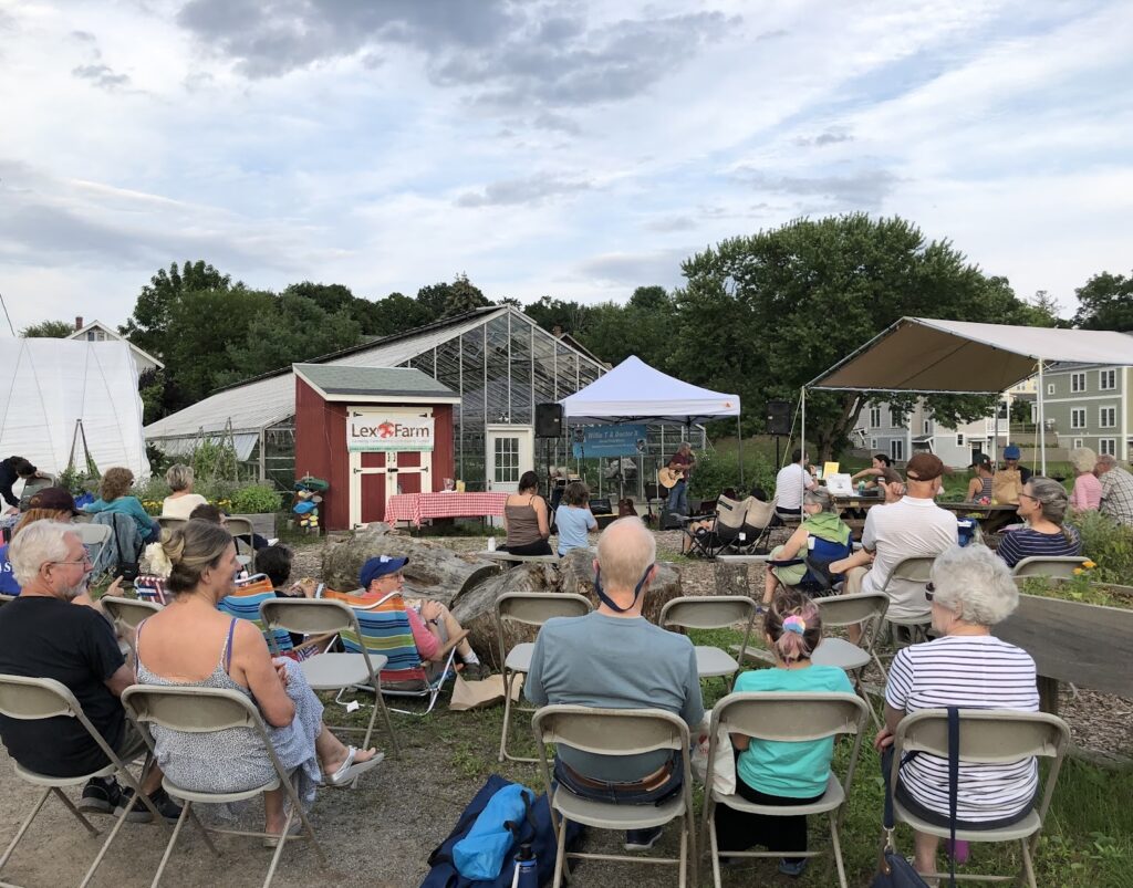 backs of people listening to concert