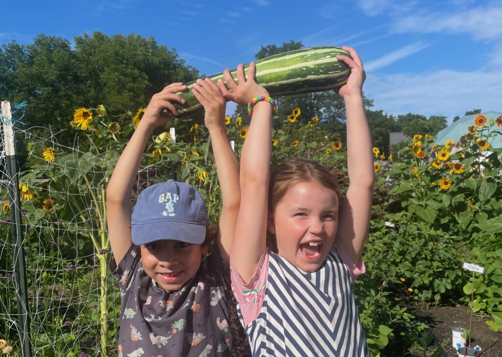happy children raising squash in the air